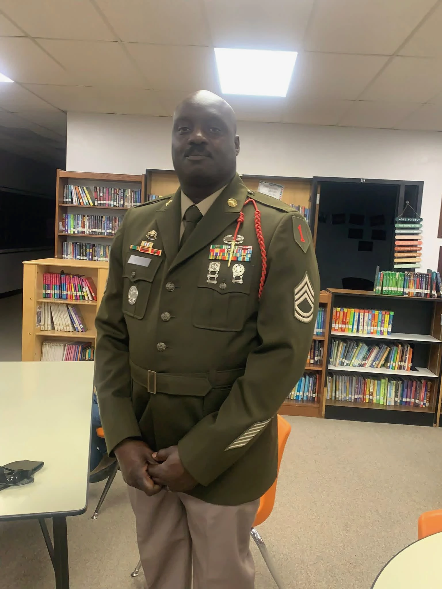 Military presenter in uniform during an educational visit in a library